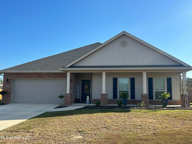 view of front of home featuring a garage, a porch, and a front lawn