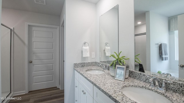 169 Mill Ct, Lucedale, MS 39452 - bathroom with a stall shower, double vanity, and wood finished floors