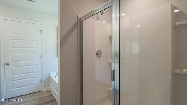 169 Mill Ct, Lucedale, MS 39452 - full bathroom with a stall shower, a bath, and wood finished floors