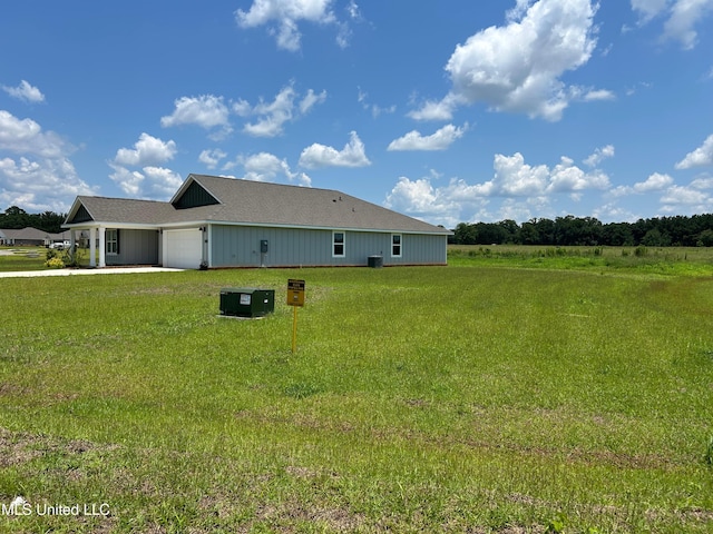 169 Mill Ct, Lucedale, MS 39452 - view of side of home featuring a garage, a lawn, roof with shingles, and driveway