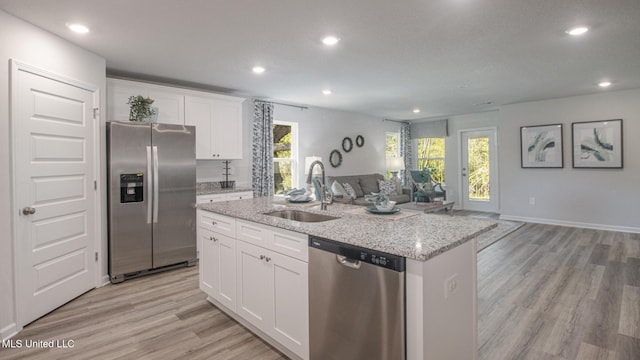 169 Mill Ct, Lucedale, MS 39452 - kitchen featuring stainless steel appliances, open floor plan, recessed lighting, light wood-style floors, and an island with sink