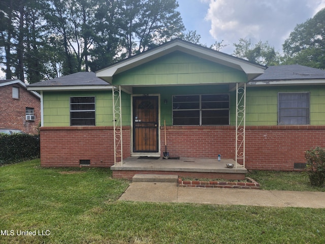 view of front of property with brick siding, crawl space, and a front yard