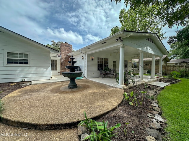 back of property with a patio area and ceiling fan