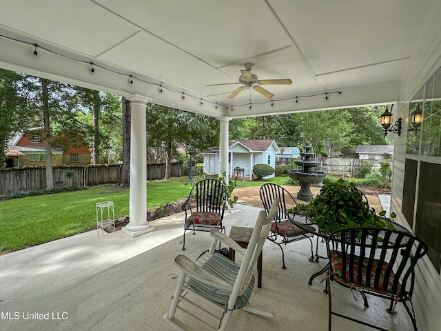 view of patio / terrace with ceiling fan and an outbuilding