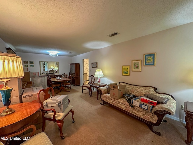 carpeted living room featuring a textured ceiling