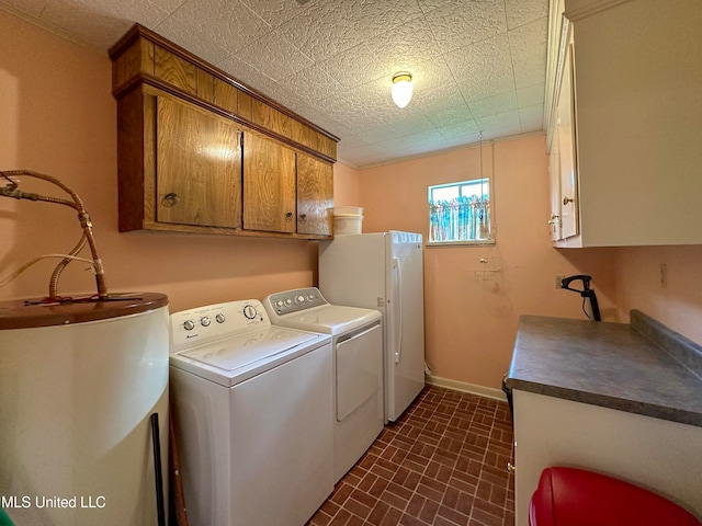 laundry room featuring independent washer and dryer, cabinets, and water heater