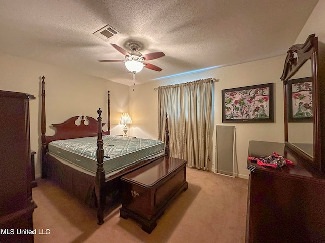 carpeted bedroom featuring a textured ceiling and ceiling fan