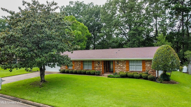 ranch-style house with a front yard and a garage