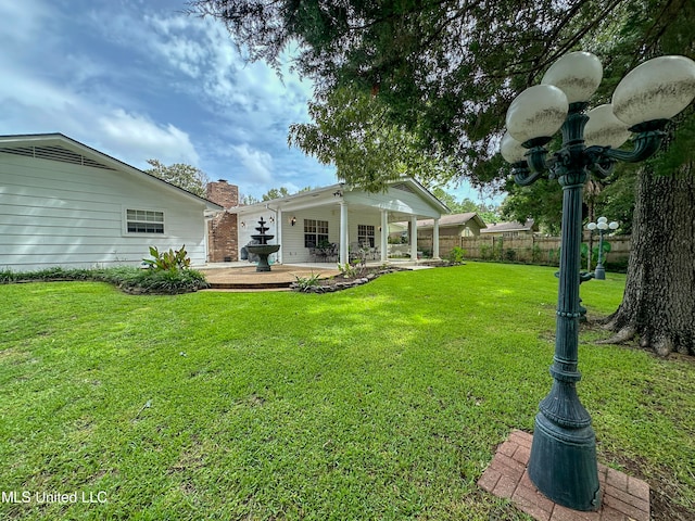 rear view of property with a patio area and a lawn