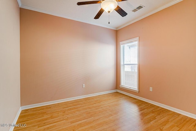 empty room featuring ceiling fan, light wood-type flooring, and ornamental molding