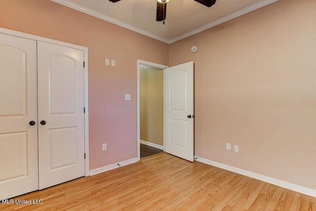 unfurnished bedroom featuring ceiling fan, ornamental molding, a closet, and light hardwood / wood-style floors