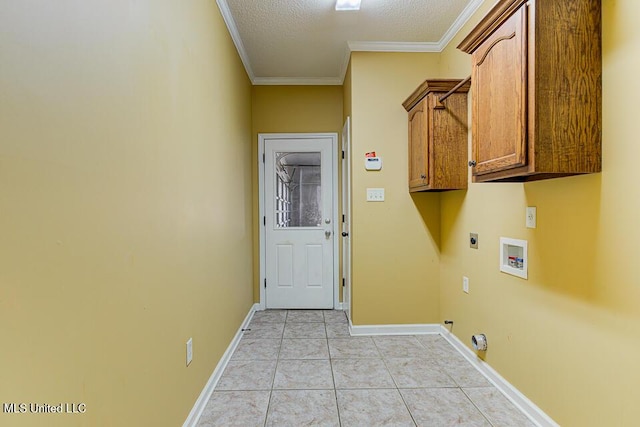 washroom featuring cabinets, washer hookup, hookup for an electric dryer, light tile patterned flooring, and crown molding