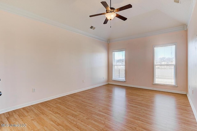 empty room featuring ceiling fan, a healthy amount of sunlight, crown molding, and light hardwood / wood-style floors