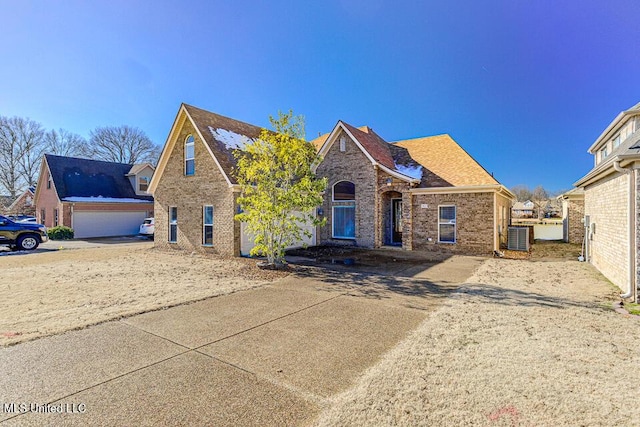 view of front property featuring a garage and central AC