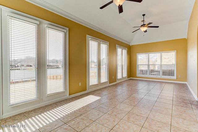 spare room featuring vaulted ceiling, ceiling fan, light tile patterned floors, and crown molding