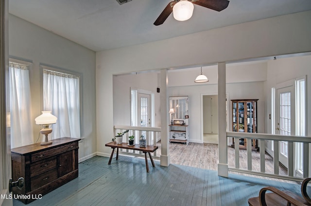 interior space with ceiling fan and wood-type flooring