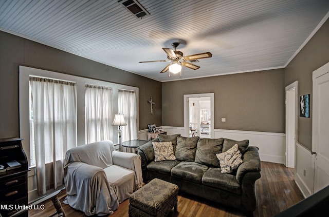 living room with dark hardwood / wood-style flooring, ceiling fan, and crown molding