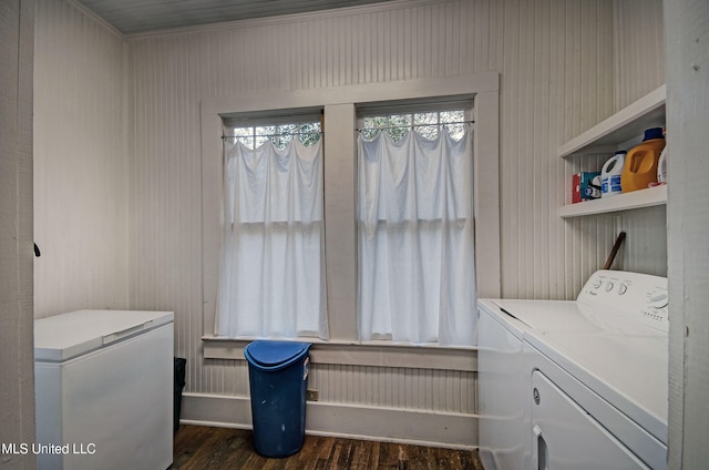 washroom with washing machine and dryer and dark hardwood / wood-style flooring