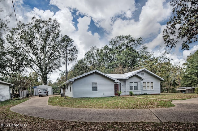 single story home with an outbuilding and a front yard