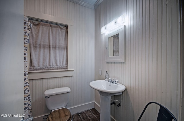 bathroom featuring ornamental molding, wood-type flooring, sink, and toilet