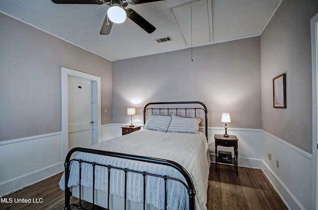 bedroom with dark wood-type flooring, ceiling fan, and crown molding