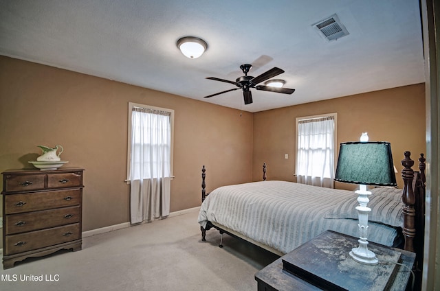 bedroom featuring ceiling fan and light carpet