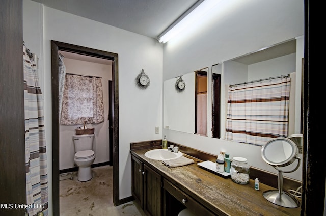 bathroom featuring concrete flooring, vanity, and toilet