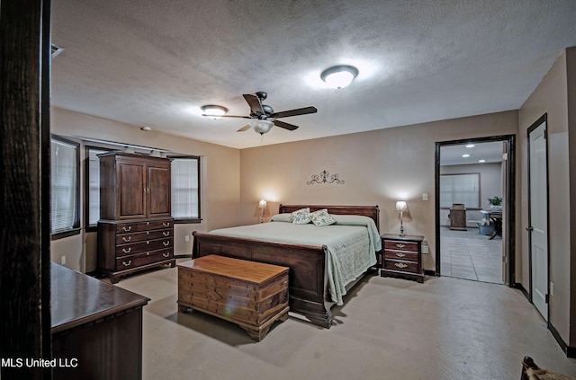 bedroom featuring a textured ceiling and ceiling fan