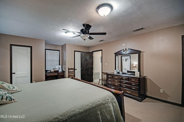 carpeted bedroom with a textured ceiling and ceiling fan