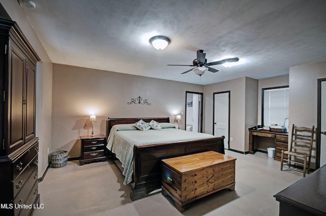 carpeted bedroom featuring a textured ceiling and ceiling fan