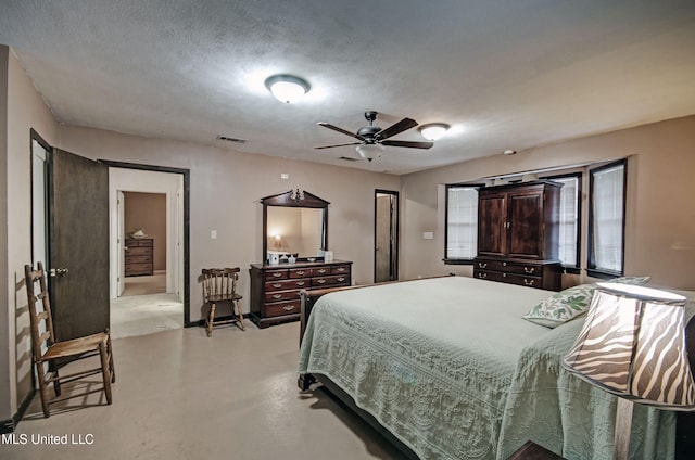 bedroom with a textured ceiling and ceiling fan