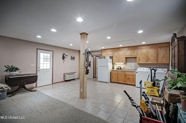 interior space with washing machine and dryer, light tile patterned floors, white refrigerator, and sink