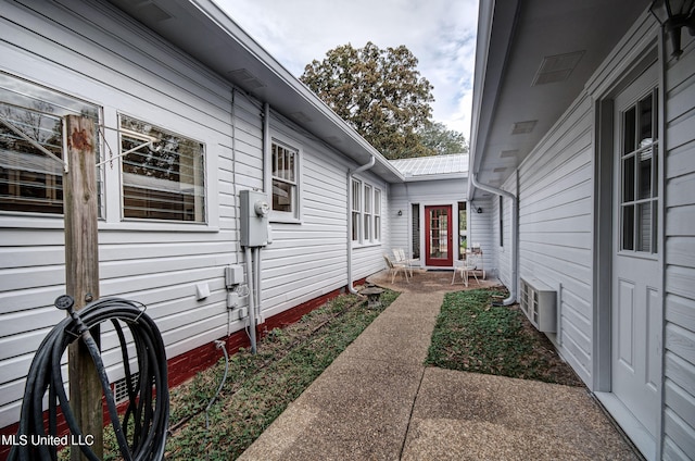 view of side of property with a patio