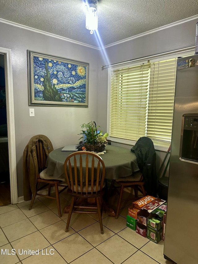 8215 Whitehead Dr, Southaven, MS 38671 - dining room featuring a textured ceiling, ornamental molding, and light tile patterned floors