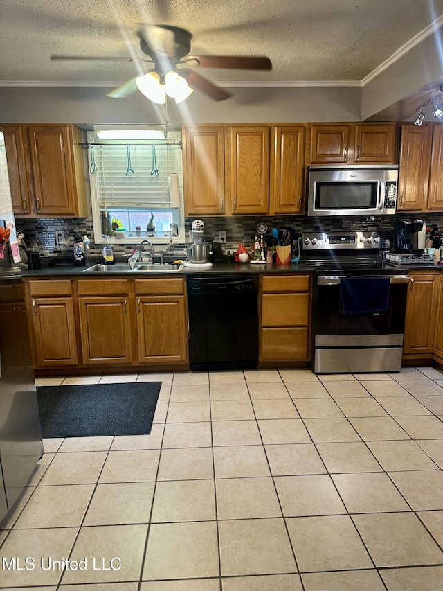 8215 Whitehead Dr, Southaven, MS 38671 - kitchen with stainless steel appliances, backsplash, a textured ceiling, dark countertops, and brown cabinetry