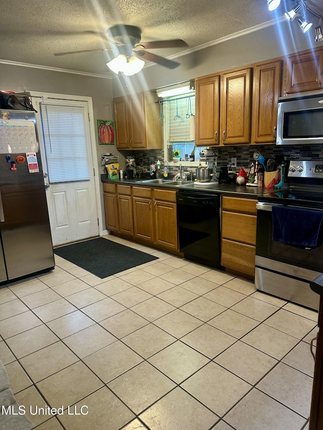 8215 Whitehead Dr, Southaven, MS 38671 - kitchen featuring appliances with stainless steel finishes, dark countertops, a textured ceiling, decorative backsplash, and a ceiling fan