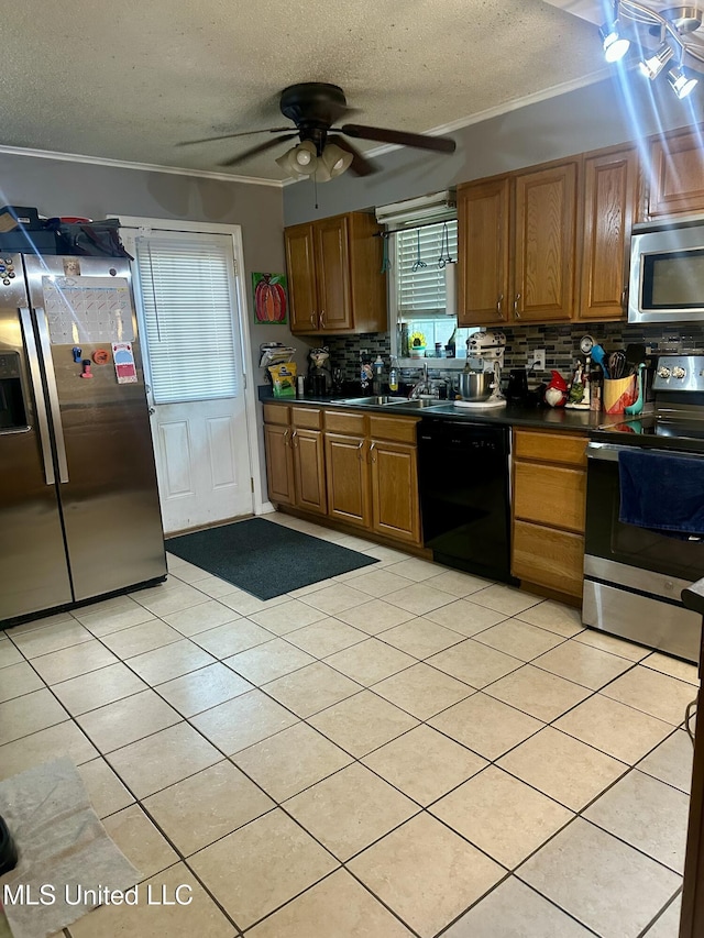 8215 Whitehead Dr, Southaven, MS 38671 - kitchen featuring stainless steel appliances, dark countertops, a textured ceiling, tasteful backsplash, and a ceiling fan