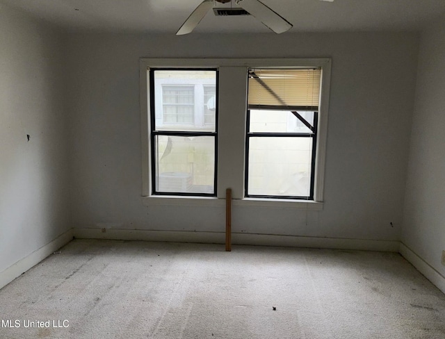 unfurnished room featuring light colored carpet and ceiling fan