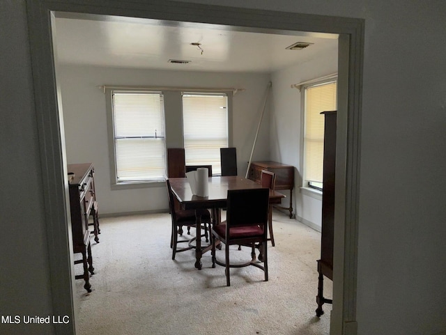 dining space with light colored carpet