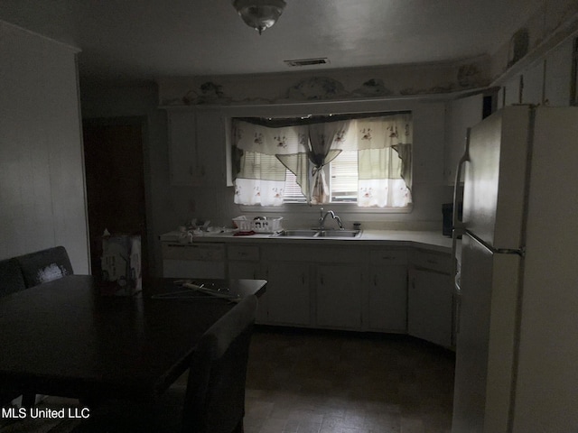 kitchen with hardwood / wood-style floors, fridge, and sink