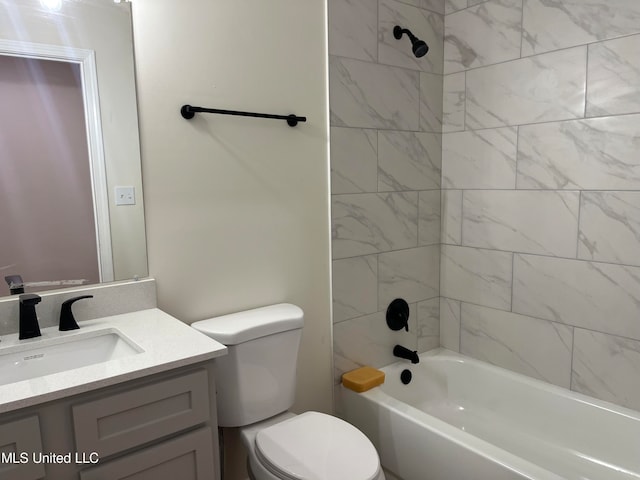 full bathroom featuring vanity, toilet, and tiled shower / bath