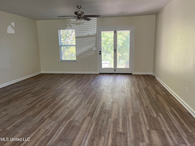 spare room with dark wood-type flooring and ceiling fan