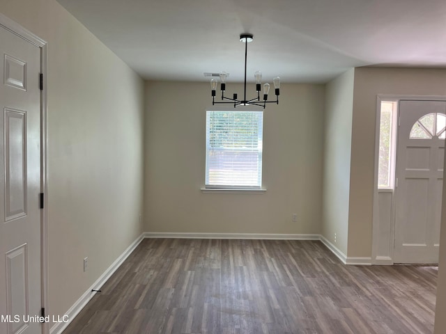 entrance foyer with a notable chandelier, hardwood / wood-style flooring, and plenty of natural light