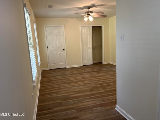 unfurnished bedroom with dark hardwood / wood-style floors and ceiling fan