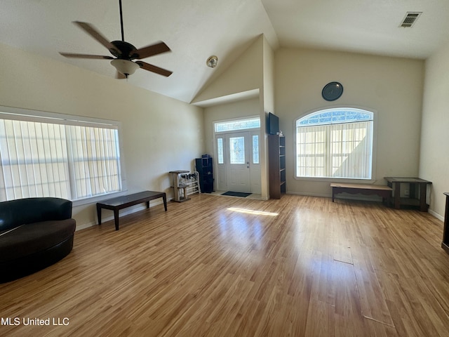 foyer with visible vents, high vaulted ceiling, wood finished floors, and a ceiling fan