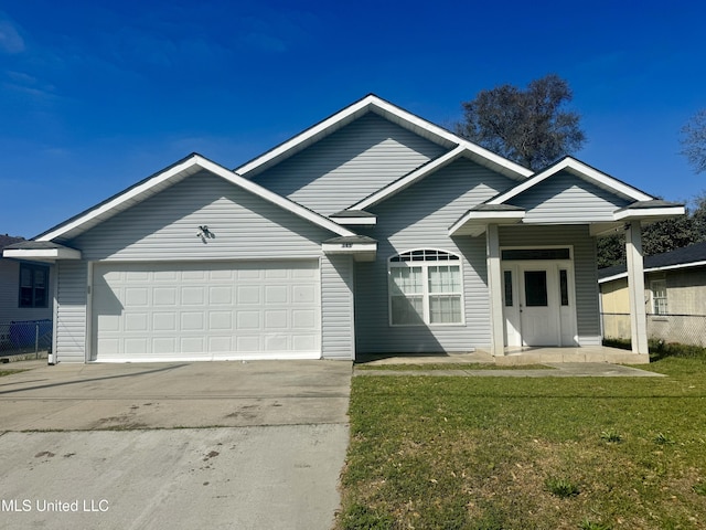 ranch-style house featuring driveway, a front yard, and a garage