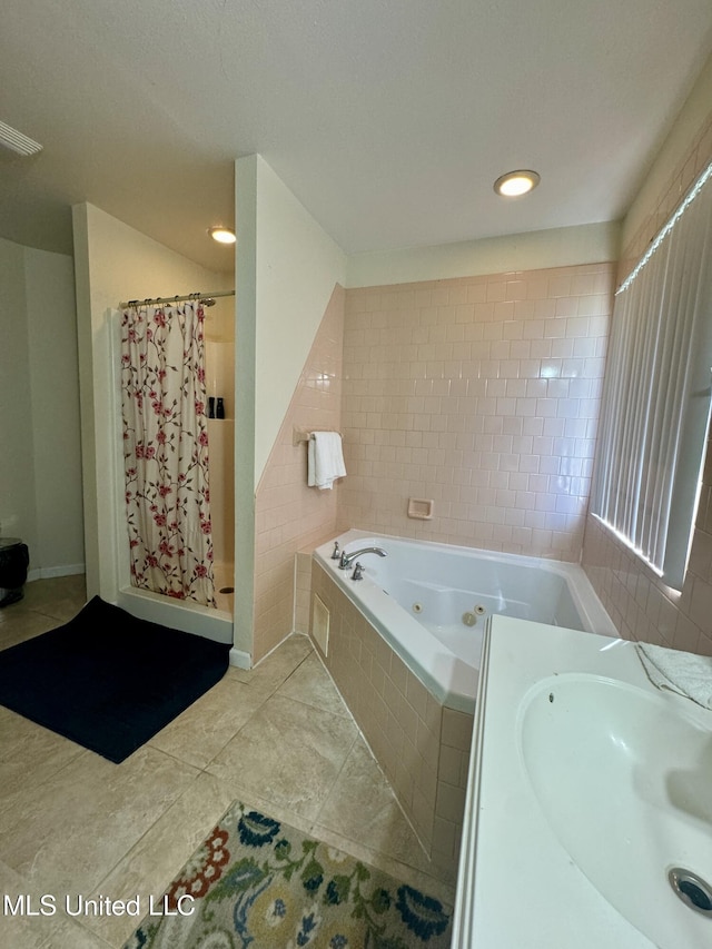 full bath featuring visible vents, a sink, a tub with jets, a shower stall, and tile patterned flooring