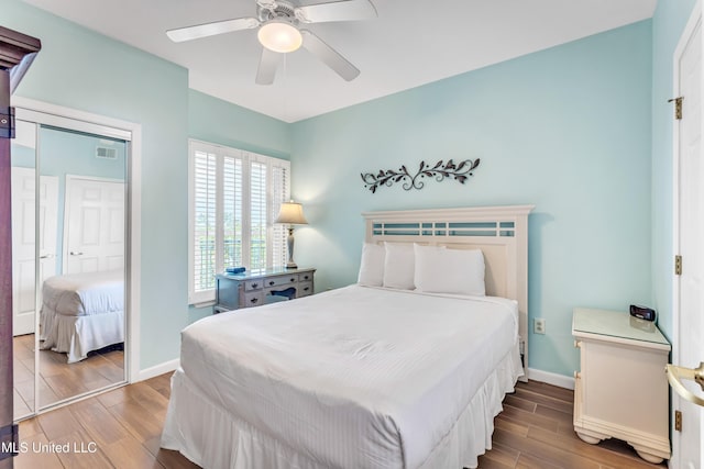 bedroom with baseboards, visible vents, ceiling fan, and wood finish floors