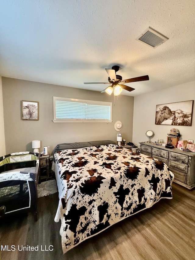 412 Monica Ln, Pearl, MS 39208 - bedroom with wood finished floors, a ceiling fan, and a textured ceiling