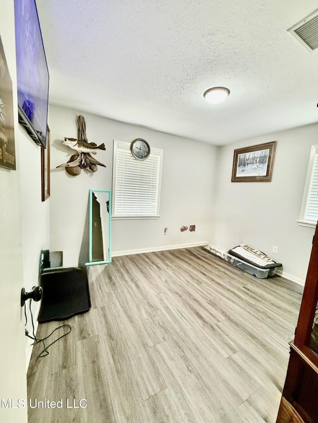 412 Monica Ln, Pearl, MS 39208 - interior space with a textured ceiling, wood finished floors, and baseboards